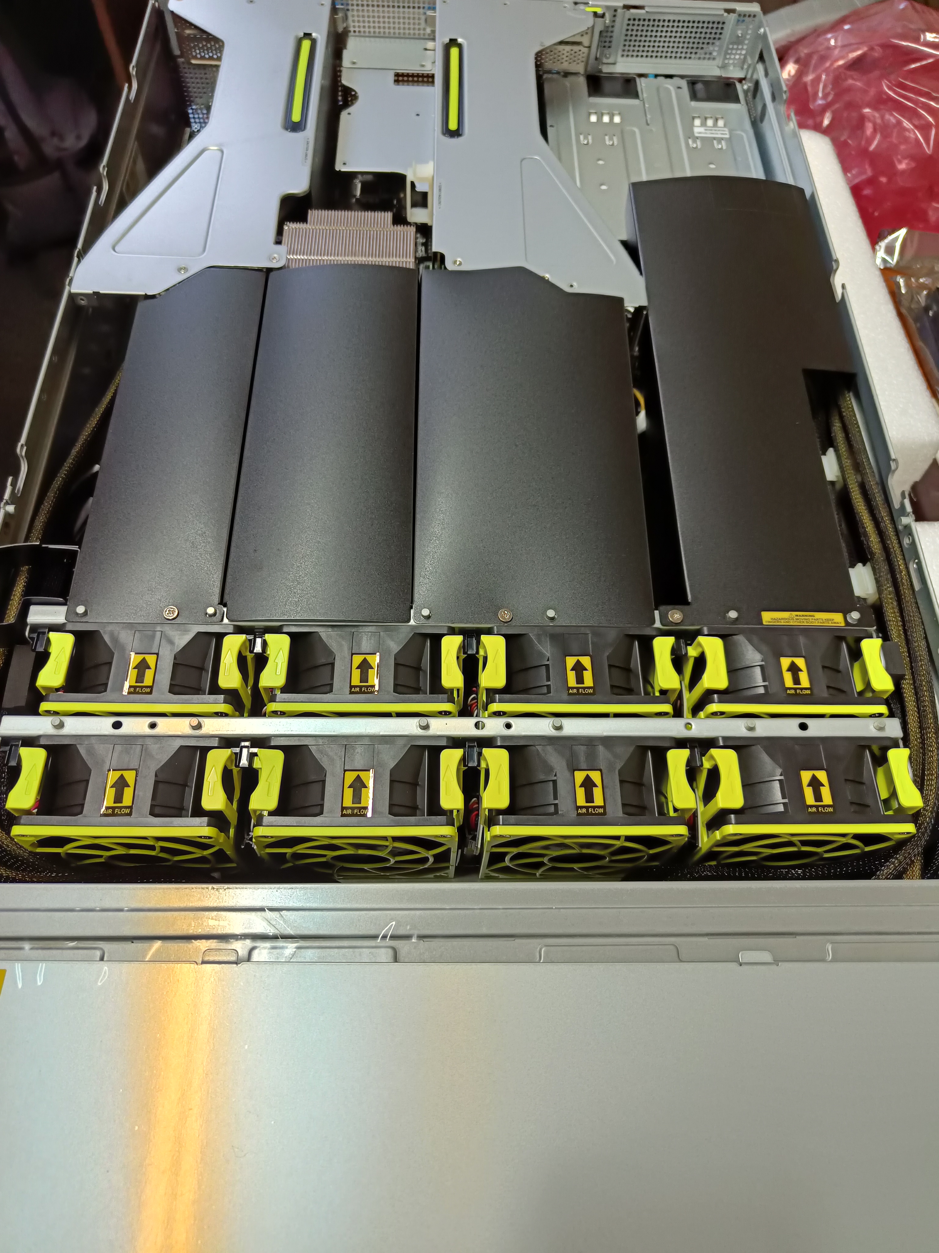 The inside of the Asus servers with big 80 mm fans and air flow tunnels. The risers are NVMe cable adapters.